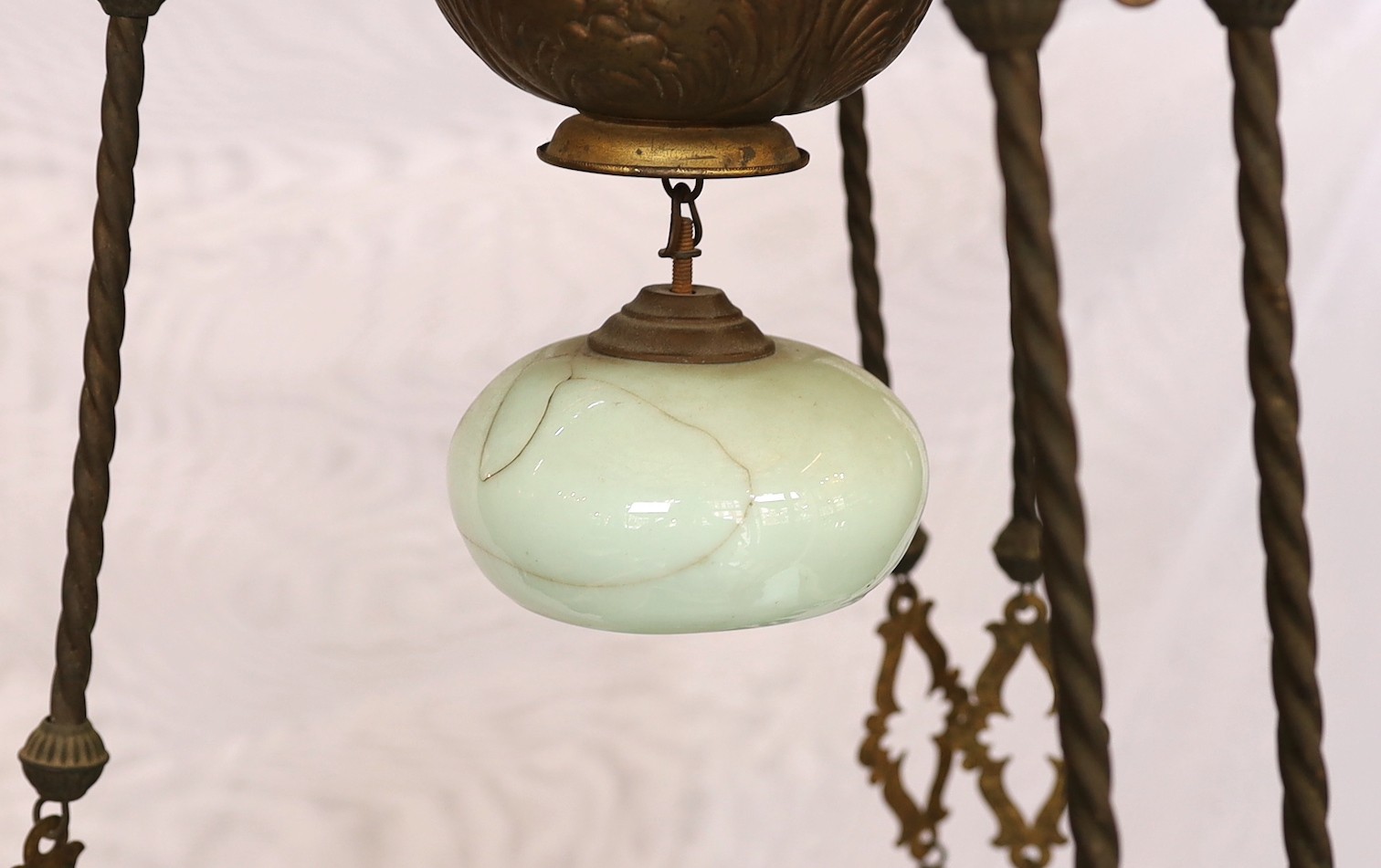 A Victorian brass counterbalanced hanging oil lamp with opaque blue glass shades and six candle sconces to the arms, height 136cm